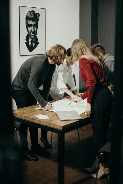 People standing around a table and collaborating